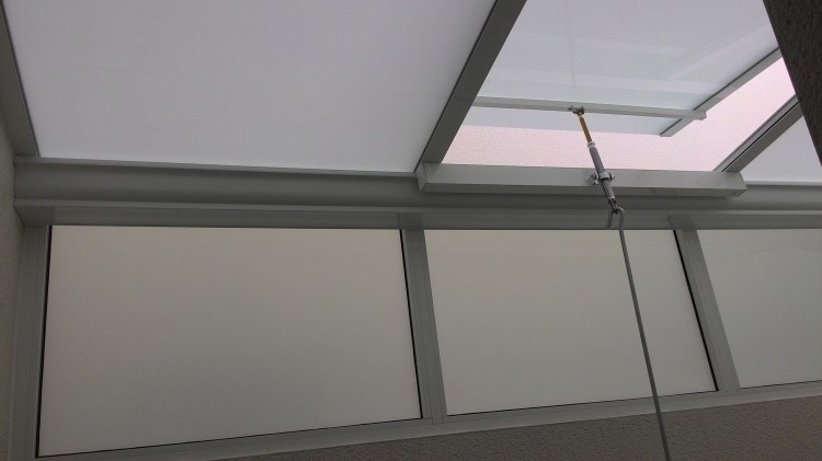 Glazed roof extension creating a bright sunroom or living area addition.